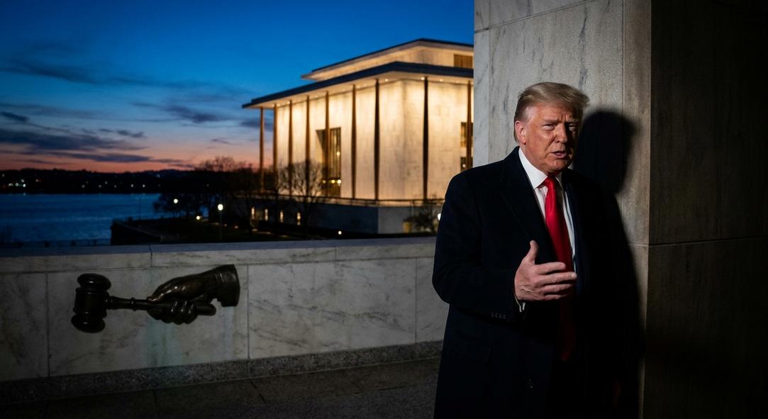 Man in suit near Lincoln Memorial at dusk