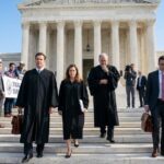 Judges exiting Supreme Court building with media nearby