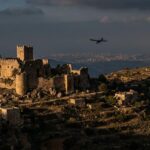 Ancient stone castle on hill at sunset